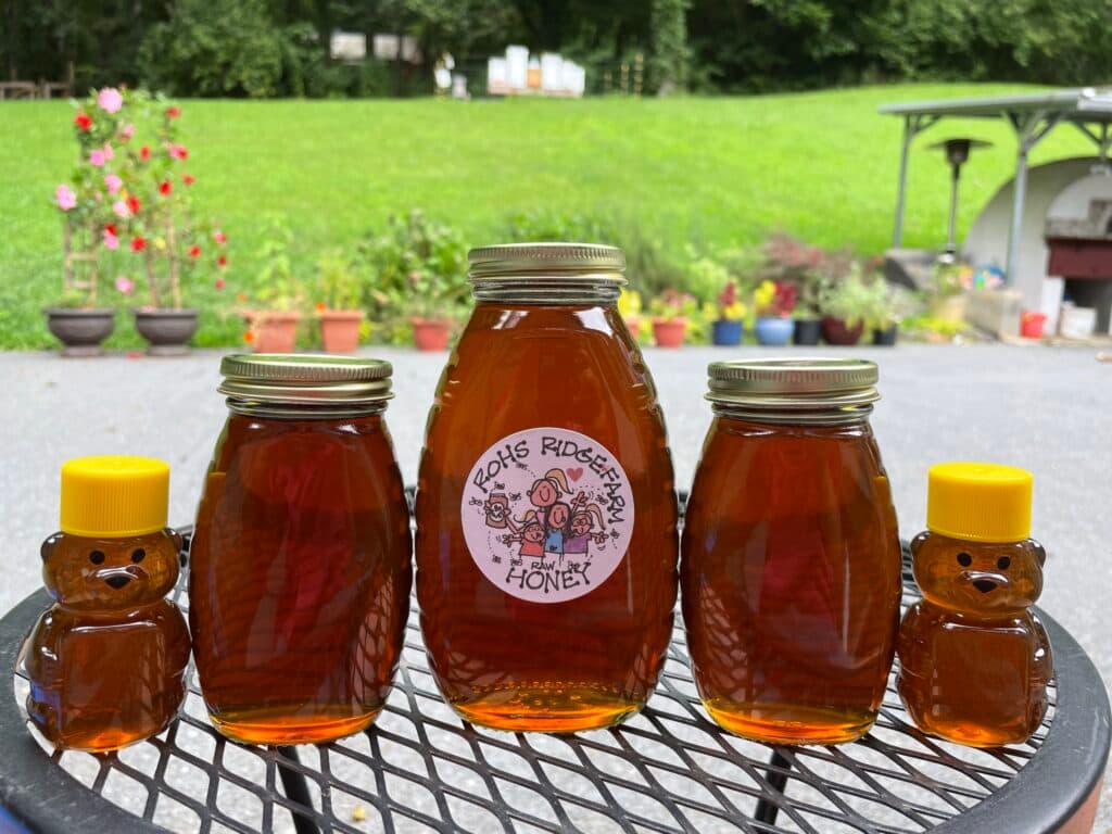 A jar of Rohs Ridge Farm raw honey and honey bears